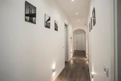 a hallway with white walls and wooden floors at Magia in Trastevere in Rome
