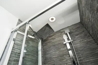 a bathroom with a wooden wall and a window at Magia in Trastevere in Rome