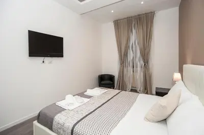 a hotel room with a bed and a television at Magia in Trastevere in Rome