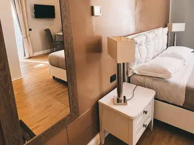 a bedroom with a bed and a mirror on the wall at Fabio Massimo Guest House in Rome