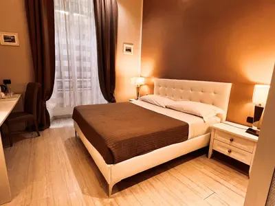 a bedroom with a bed and a window at Fabio Massimo Guest House in Rome