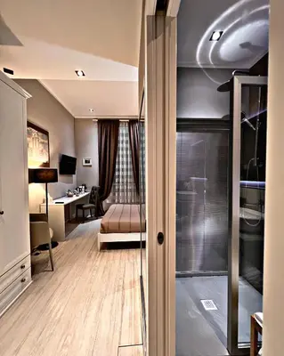a hotel room with a bed and a desk at Fabio Massimo Guest House in Rome