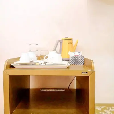 a table with plates and a coffee maker on it at Persia Collection Trevi in Rome