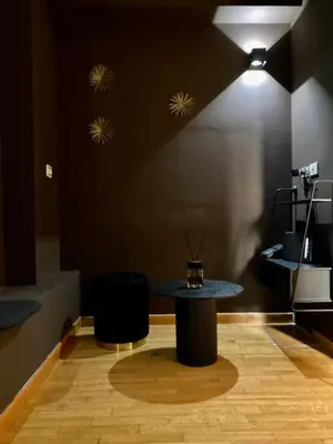 a table and two stools in a room at Persia Collection Trevi in Rome