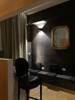 a waiting room with two chairs and a mirror at Persia Collection Trevi in Rome