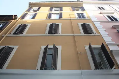 a tall yellow building with many windows at Persia Collection Trevi in Rome