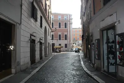 an alley with buildings and a car driving down a street at Persia Collection Trevi in Rome