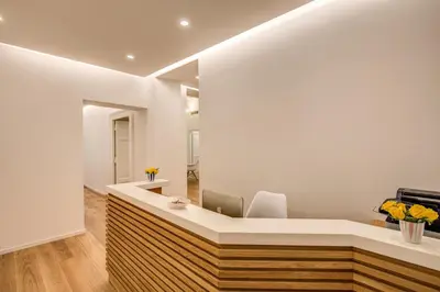 an office with a reception desk and a mirror at Dopodomani Suite in Rome
