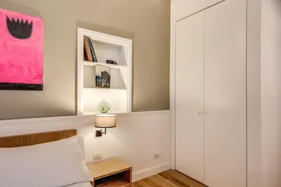 a bedroom with a bed and a mirror and a table at Dopodomani Suite in Rome