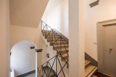 a spiral staircase in a home with white walls at Dopodomani Suite in Rome