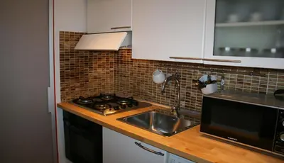 a kitchen with a sink and a stove at Sforza Apartment in Rome