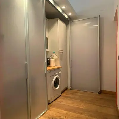 a laundry room with a washing machine and a washer at Sforza Apartment in Rome