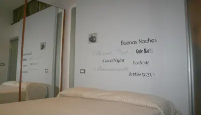 a bedroom with a bed with words on the wall at Sforza Apartment in Rome