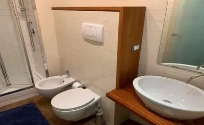 a bathroom with a toilet and a sink at Sforza Apartment in Rome