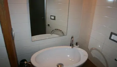a bathroom with a sink and a mirror at Sforza Apartment in Rome