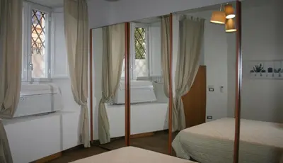a bedroom with a bed and a window at Sforza Apartment in Rome