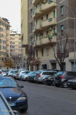 a row of cars parked on the side of a city street at Homesuitehome in Rome