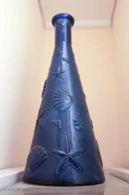 a blue vase sitting on top of a table at Homesuitehome in Rome