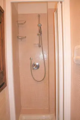 a shower with a glass door in a bathroom at Navona Secret Suite in Rome