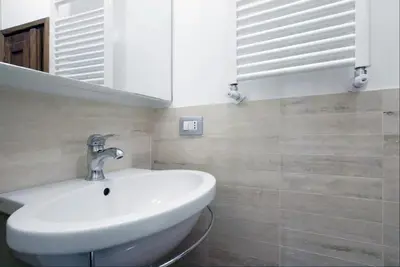 a bathroom with a sink and a mirror at Navona Secret Suite in Rome