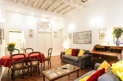 a living room with a table and a couch at Vicolo Torretta - FromHometoRome in Rome