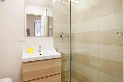 a bathroom with a sink and a shower at Vicolo Torretta - FromHometoRome in Rome