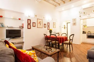 a living room with a couch and a table at Vicolo Torretta - FromHometoRome in Rome