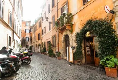 a group of motorcycles parked on a cobblestone street at Vicolo Torretta - FromHometoRome in Rome