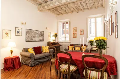 a living room with a table and a couch at Vicolo Torretta - FromHometoRome in Rome