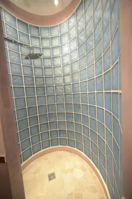 a bathroom with a shower with blue tiled walls at Bed&BikeRome Suite in Rome
