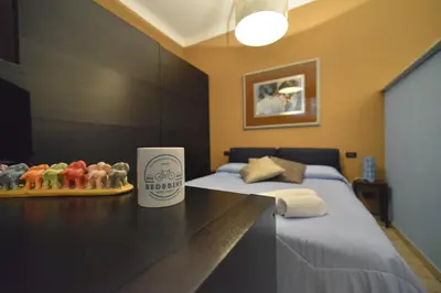 a hotel room with a bed and a cup on a desk at Bed&BikeRome Suite in Rome