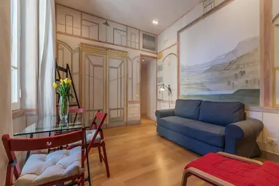a living room with a couch and a table at Domus Claudiae - FromHometoRome in Rome