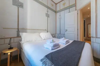 a bedroom with a white bed with towels on it at Domus Claudiae - FromHometoRome in Rome
