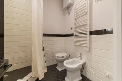 a bathroom with a toilet and a bidet at Domus Claudiae - FromHometoRome in Rome