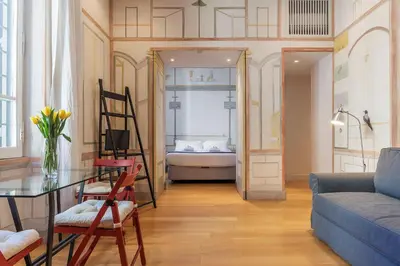 a living room with a couch and a table at Domus Claudiae - FromHometoRome in Rome