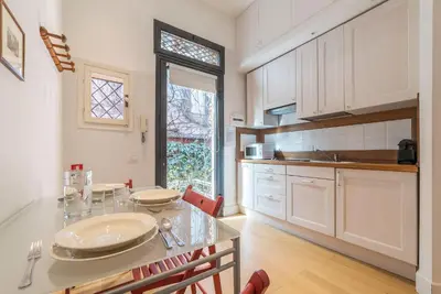 a kitchen with a table with plates on it at Domus Claudiae - FromHometoRome in Rome