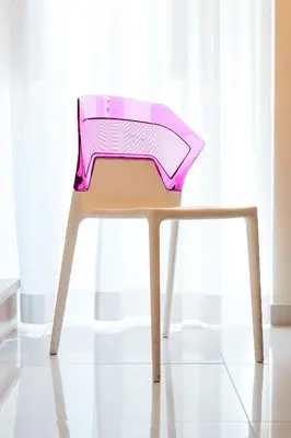 a pink chair sitting in front of a window at Restart Accommodations Farnesina in Rome