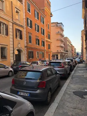 a row of parked cars on a city street at Restart Accommodations Farnesina in Rome
