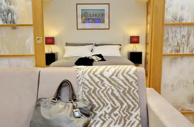 a bedroom with a bed with a purse on it at VENETO COMFORTABLE Apartment in Rome