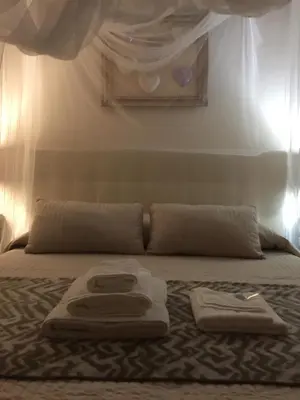 a bed with two towels on top of it at VENETO COMFORTABLE Apartment in Rome