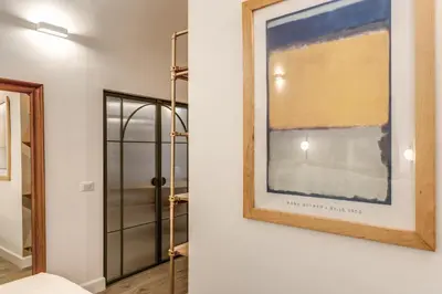 a picture hanging on a wall next to a door at Casa Alessandra in Rome