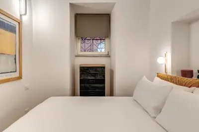 a bedroom with a white bed and a window at Casa Alessandra in Rome