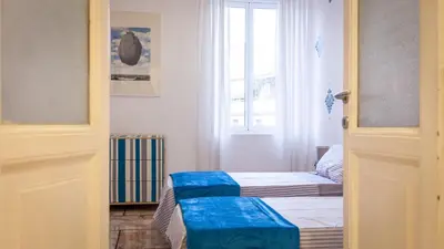 a small room with two beds and a window at Rental in Rome Otranto Relax in Rome