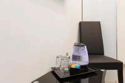 a tray with a blender and other items on a chair at Domus Arena in Rome