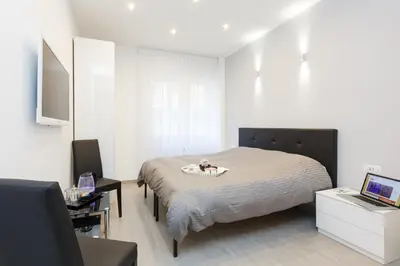 a bedroom with a bed and a desk and a laptop at Domus Arena in Rome