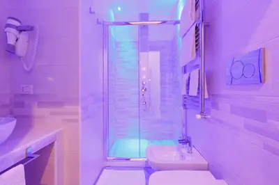 a bathroom with a shower and a toilet and a sink at Domus Arena in Rome