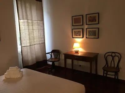a bedroom with a bed and a table and chairs at Porta Latina Apartment in Rome