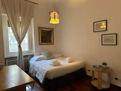 a bedroom with a bed with two towels on it at Porta Latina Apartment in Rome