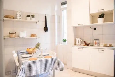 a kitchen with a table with a table cloth at Porta Latina Apartment in Rome