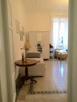 a living room with a table and a bed at A casa di Fiamma in Rome
